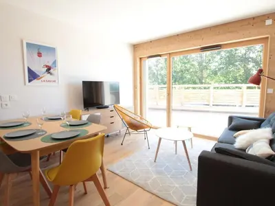 a living room with a table and a couch at Appartement ski aux pieds, 3 pièces, 6 pers, terrasse sud, près des Carroz - FR-1-572-248 in Les Carroz d'Araches