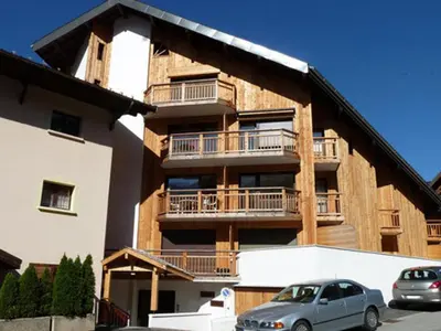 a building with cars parked in front of it at Studio pour 2 près du centre de Samoëns - FR-1-629-77 in Samoëns
