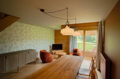 a dining room with a large wooden table and chairs at Best Western Plus Pays du Mont Blanc in Sallanches