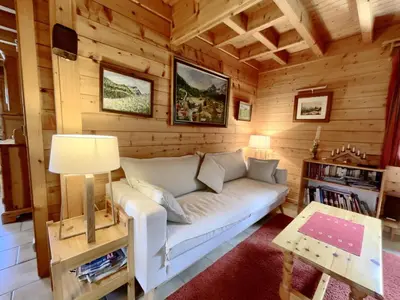 a living room with a couch in a log cabin at Chalet 3 chambres calme, poêle à bois, proche piste et village, 6/8 pers, garage et parking - FR-1-572-243 in Les Carroz d'Araches