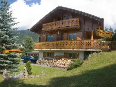 a large log house with a lot of fire wood at Chalet 3 chambres calme, poêle à bois, proche piste et village, 6/8 pers, garage et parking - FR-1-572-243 in Les Carroz d'Araches