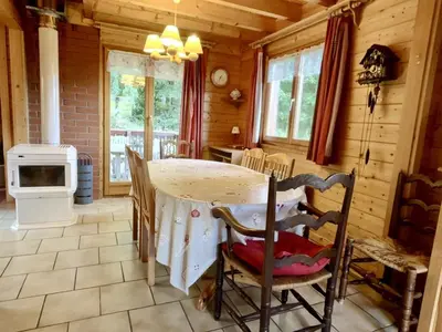 a kitchen with a table and chairs in a cabin at Chalet 3 chambres calme, poêle à bois, proche piste et village, 6/8 pers, garage et parking - FR-1-572-243 in Les Carroz d'Araches