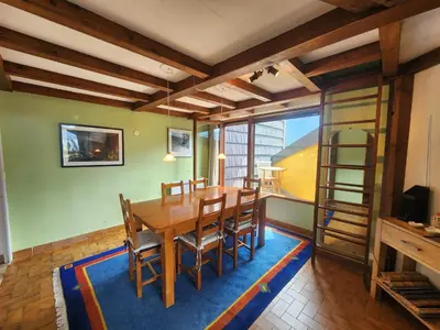 a dining room with a wooden table and chairs at Charmant appartement 2 pièces mezzanine, animaux admis, Samoëns - FR-1-629-53 in Samoëns