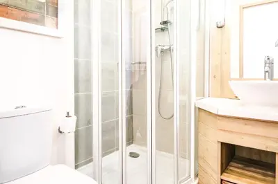 a bathroom with a shower and a sink at Two internally connecting 2-bed apartments with shared private entrance in Flaine