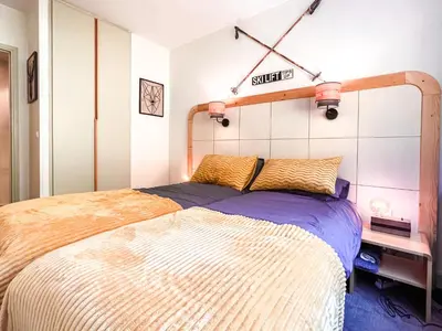 a bedroom with a bed and a sign on the wall at Large 2-Bedroom Apartment, Centre of Flaine Foret in Flaine