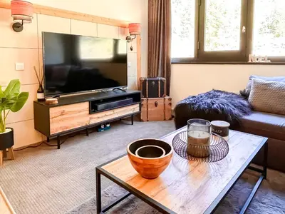 a living room with a television and a coffee table at Large 2-Bedroom Apartment, Centre of Flaine Foret in Flaine