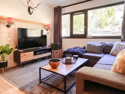a living room with a couch and a tv at Large 2-Bedroom Apartment, Centre of Flaine Foret in Flaine