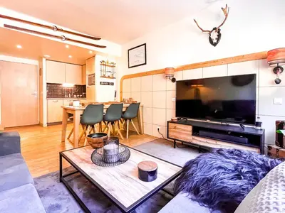 a living room with a large flat screen tv at Large 2-Bedroom Apartment, Centre of Flaine Foret in Flaine