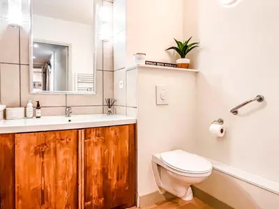 a bathroom with a sink and a toilet and a mirror at Large 2-Bedroom Apartment, Centre of Flaine Foret in Flaine