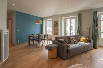 a living room with a couch and a table at Les Aiguilles- Town centre luxury 2 bedroom apartment in Chamonix-Mont-Blanc