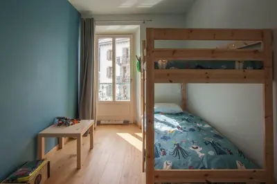 a bedroom with a bunk bed and a desk at Les Aiguilles- Town centre luxury 2 bedroom apartment in Chamonix-Mont-Blanc