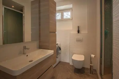 a bathroom with a sink and a toilet at Les Aiguilles- Town centre luxury 2 bedroom apartment in Chamonix-Mont-Blanc