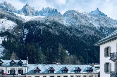 a group of buildings in front of a mountain at Les Aiguilles- Town centre luxury 2 bedroom apartment in Chamonix-Mont-Blanc