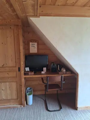 a room with a desk with a computer in a cabin at Les Grands Montets Hotel & Spa in Chamonix-Mont-Blanc