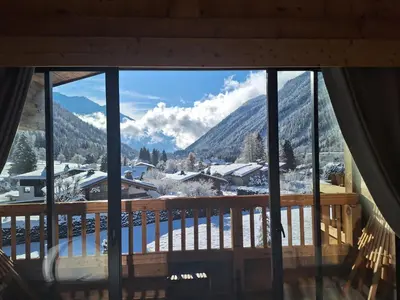a view of a snowy mountain from a window at Les Grands Montets Hotel & Spa in Chamonix-Mont-Blanc
