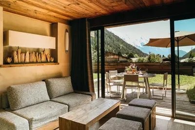 a living room with a couch and a table at Les Grands Montets Hotel & Spa in Chamonix-Mont-Blanc