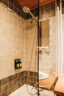 a bathroom with a shower and a sink at Les Grands Montets Hotel & Spa in Chamonix-Mont-Blanc