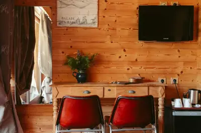 two red chairs in a room with a television at Les Grands Montets Hotel & Spa in Chamonix-Mont-Blanc
