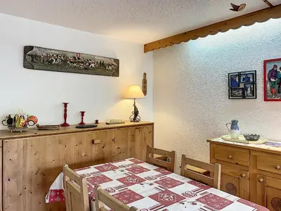 a dining room with a table and a table and chairs at Joli 2 pièces + studio au centre de Combloux - FR-1-560-74 in Combloux