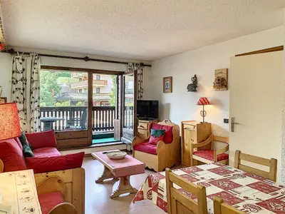 a living room filled with furniture and a balcony at Joli 2 pièces + studio au centre de Combloux - FR-1-560-74 in Combloux