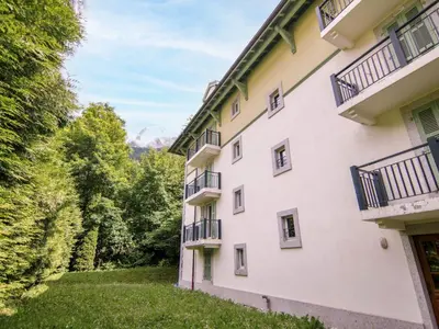 a living room with a couch and a table at Apartment Les Jardins de l'Astoria by Interhome in Chamonix-Mont-Blanc
