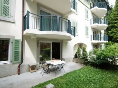 a patio with a table and a balcony at Apartment Les Jardins de l'Astoria by Interhome in Chamonix-Mont-Blanc