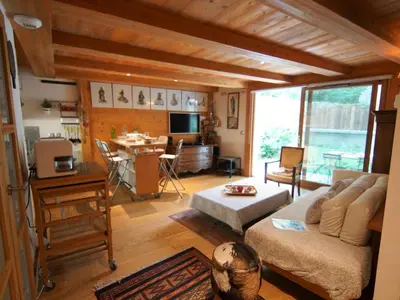 two beds in a room with a book shelf at Apartment Les Jardins de l'Astoria by Interhome in Chamonix-Mont-Blanc