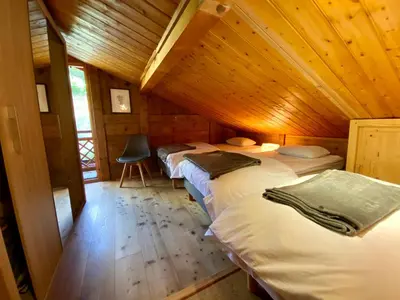 a room with two beds in a wooden cabin at Chalet massif du Mont Blanc St Gervais Megeve in Saint-Gervais-les-Bains