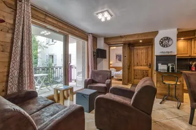 a living room with furniture and a balcony at Villa Vallet- Newly renovated 2 bedroom nestled just off the main street in Chamonix-Mont-Blanc