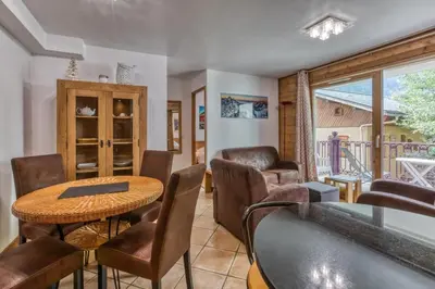 a dining room with a table and chairs at Villa Vallet- Newly renovated 2 bedroom nestled just off the main street in Chamonix-Mont-Blanc
