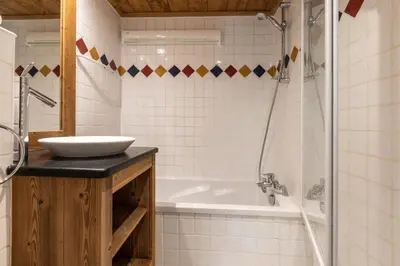a bathroom with a sink and a bath tub at Villa Vallet- Newly renovated 2 bedroom nestled just off the main street in Chamonix-Mont-Blanc