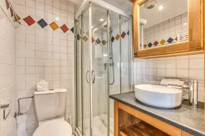 a bathroom with a toilet and a sink and a shower at Villa Vallet- Newly renovated 2 bedroom nestled just off the main street in Chamonix-Mont-Blanc