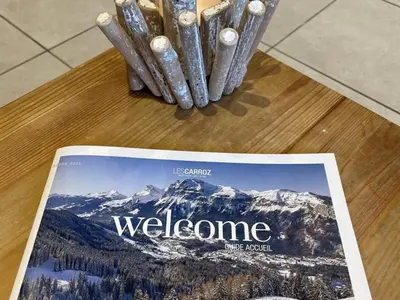 a magazine sitting on top of a table with mountains at Ferme rénovée 4 ch, 3 sdb, PARKING, WIFI, proche pistes et commerces - FR-1-572-25 in Arâches-la-Frasse