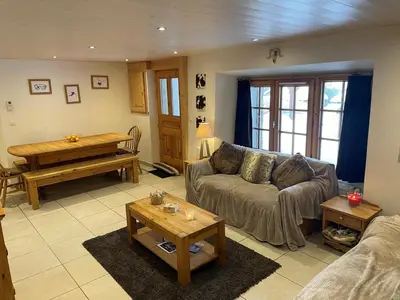 a living room with a couch and a piano at Ferme rénovée 4 ch, 3 sdb, PARKING, WIFI, proche pistes et commerces - FR-1-572-25 in Arâches-la-Frasse
