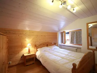 a bedroom with a bed in a wooden room at Ferme rénovée 12 pers, 450m des pistes, navette gratuite, balcon S-O, parking, WIFI - FR-1-572-23 in Arâches-la-Frasse
