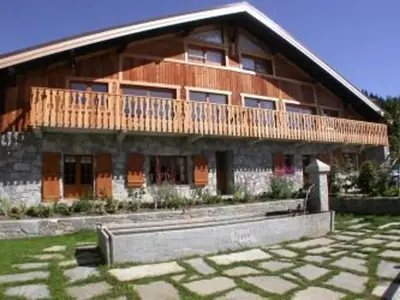 a large wooden building with a wooden deck on it at Ferme rénovée 12 pers, 450m des pistes, navette gratuite, balcon S-O, parking, WIFI - FR-1-572-23 in Arâches-la-Frasse