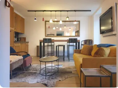 a living room with a couch and a table at Appartement Paccard, Centre Ville in Chamonix-Mont-Blanc