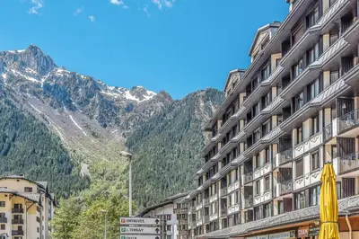 a large building with a view of a mountain at Appartement Courmayeur - Welkeys in Chamonix-Mont-Blanc