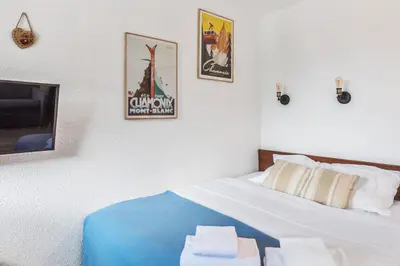 a bedroom with a bed with two towels on it at Appartement Courmayeur - Welkeys in Chamonix-Mont-Blanc