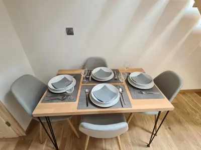 a wooden table with chairs and plates on it at Chalet Cristal Trail in Chamonix-Mont-Blanc