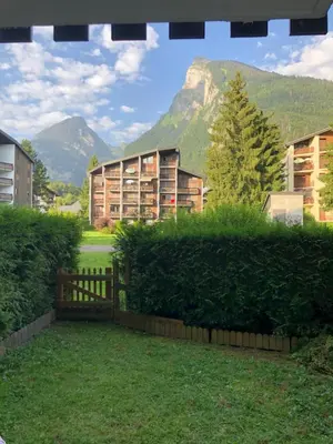 a view of some buildings with mountains in the background at Studio 4 personnes RDC avec jardin et parking sous terrain in Samoëns