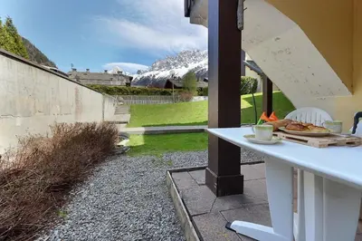 a small bedroom with a bed and a dresser at Le Petit Cocon in Les Houches