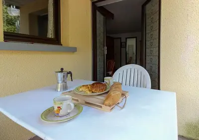 a table with two plates of bread and a cup of coffee at Le Petit Cocon in Les Houches
