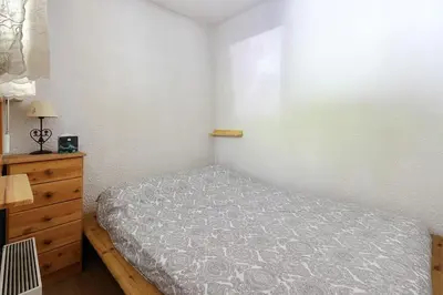 an open door to a bedroom with a bed in it at Le Petit Cocon in Les Houches