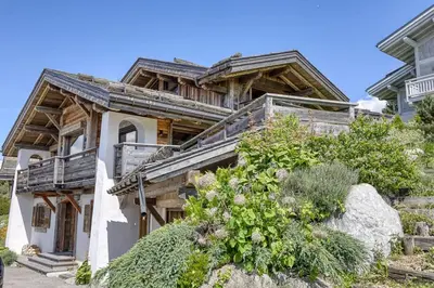 a large wooden house with a balcony at Chalet Carline in Combloux