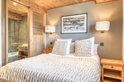 a bedroom with a bed with two pillows at Chalet Carline in Combloux