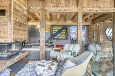 a living room with wooden walls and wooden floors at Chalet Carline in Combloux