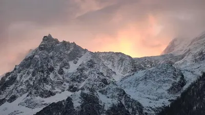 a snow covered mountain with a sunset in the background at Les Alpages - Newly Renovated - 2bed - Equipment Storage - Mont-Blanc Views in Les Houches