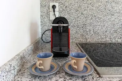 two coffee cups sitting on top of a counter at Les Alpages - Newly Renovated - 2bed - Equipment Storage - Mont-Blanc Views in Les Houches