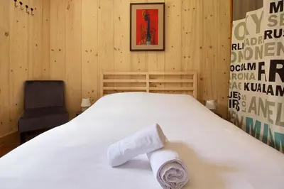 a bedroom with a bed with two towels on it at Les Alpages - Newly Renovated - 2bed - Equipment Storage - Mont-Blanc Views in Les Houches